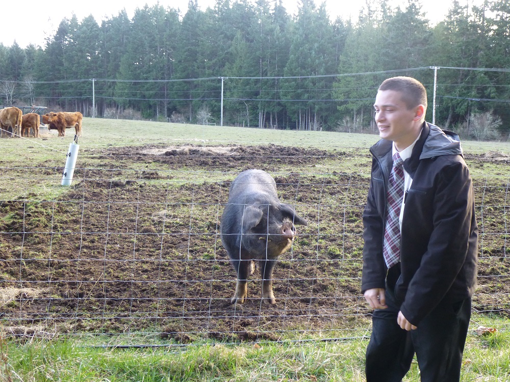 Elder Skyler Rushton with pig